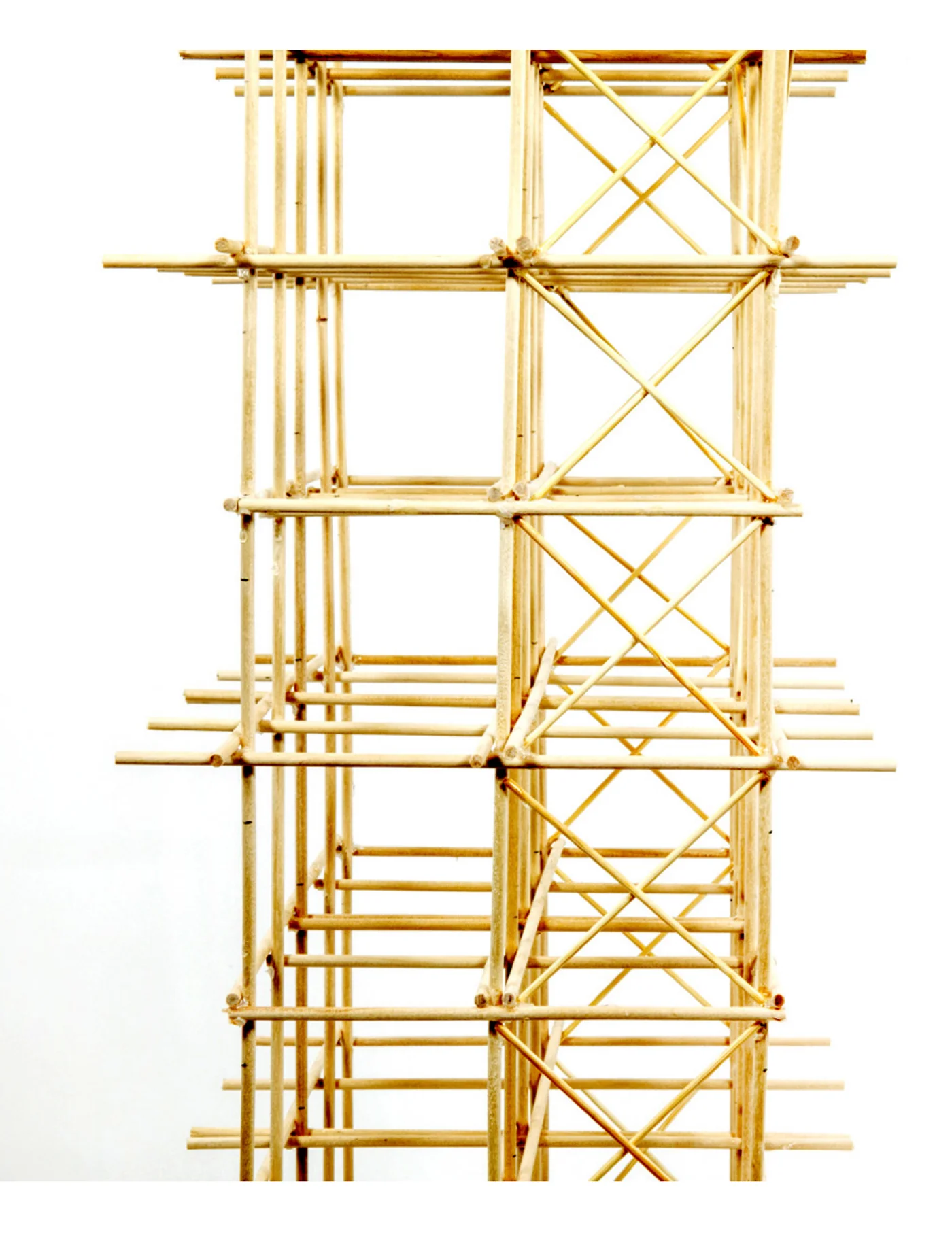 Photograph of the bamboo timber tower frame, showing the cross-bracing pattern: an X-braced rear panel beside the unbraced fronts
