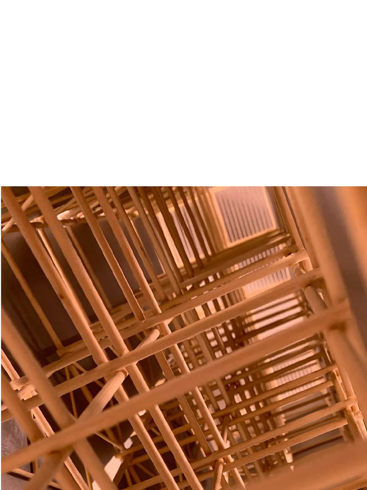 Atmospheric close-up of the timber frame inside the model, lit in warm tones