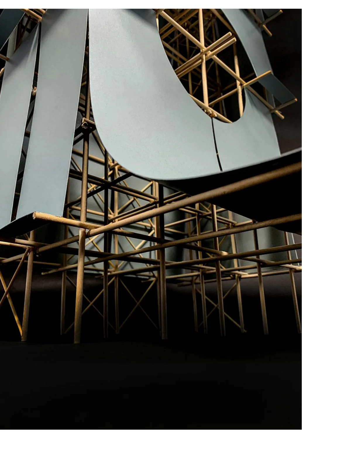 Looking up inside the model, the curved metallic skin visible above the slender timber frame