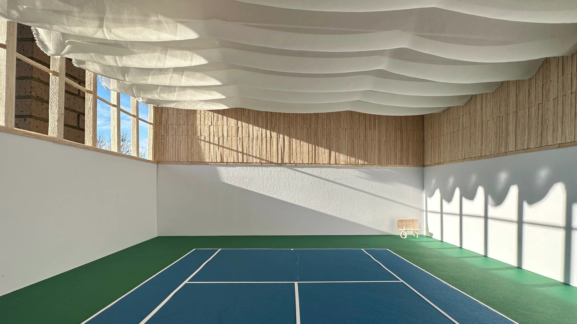 Alternate angle of the sports court, showing the wavy ceiling spanning the full width of the hall