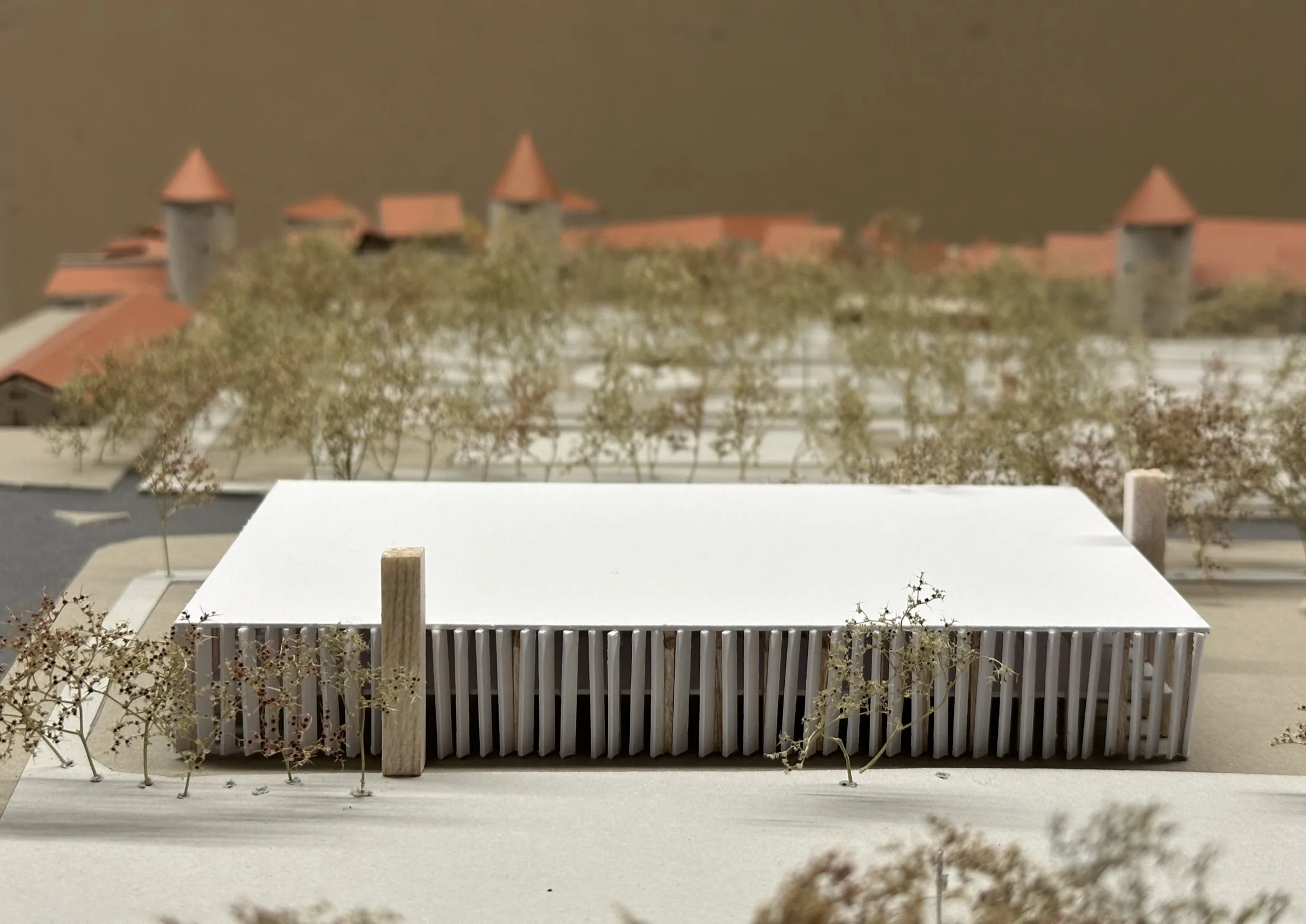 Physical model of a louvred sports hall set within Tallinn's old town