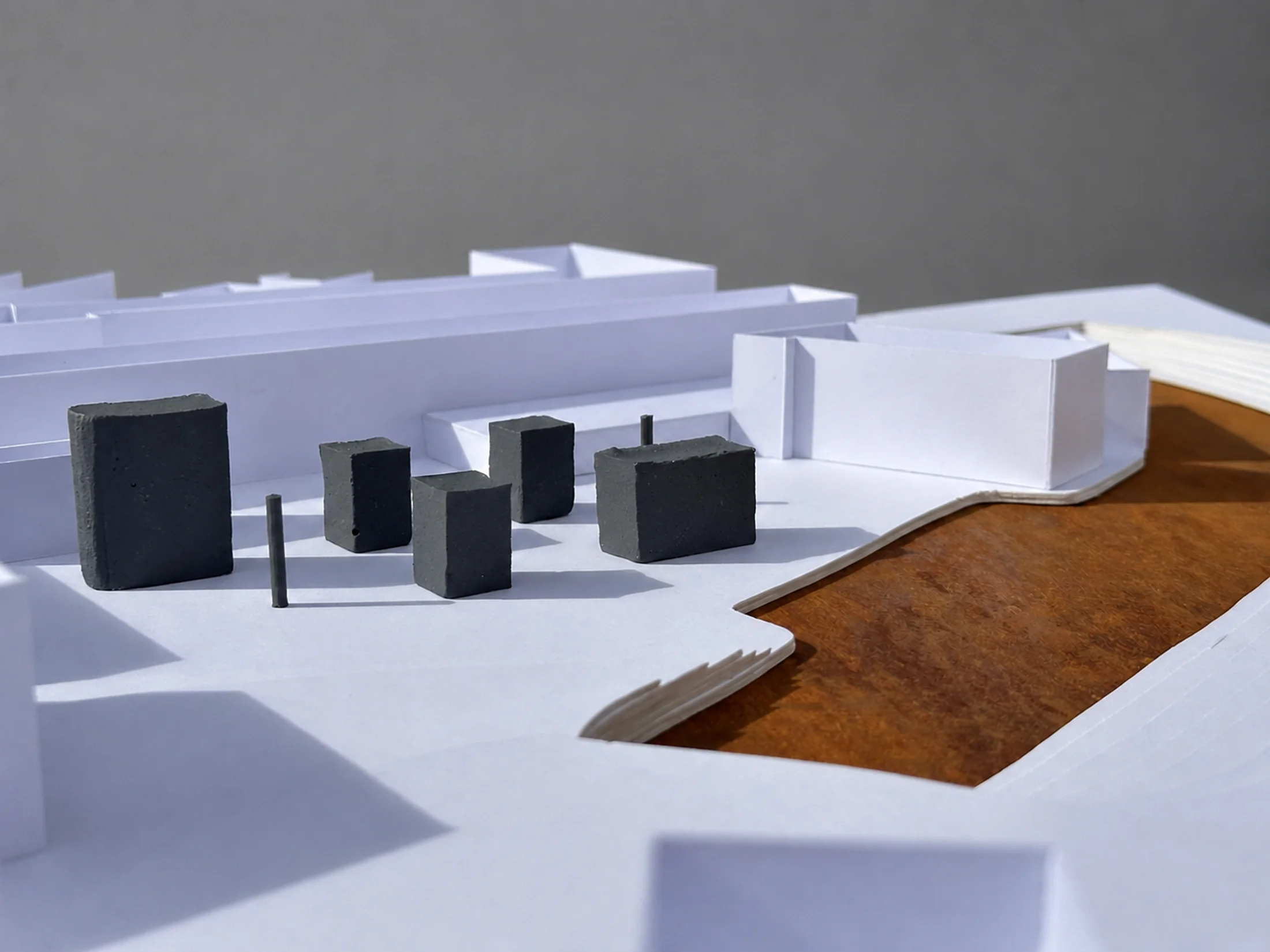 Physical site model showing the proposal as small grey blocks set into the existing Camden urban fabric beside the canal